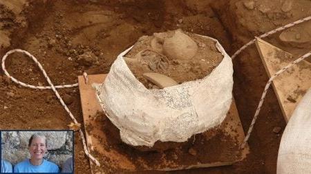 A jug of coins encrusted in dirt at the Huqoq dig site. In the bottom corner of the image is a separate cutout image of a woman, Jodi Magness.